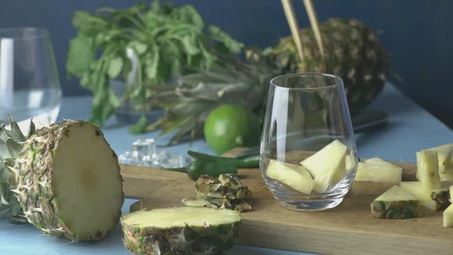 Woman prepared Spicy pineapple jalapeno mezcalita or margarita for Cinco de Mayo is a refreshing cocktail made with pineapple, cilantro, jalapeno and mexican distilled alcoholic beverage