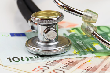 Stethoscope and euro banknotes on white background