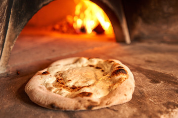 Blank for Fruit pizza. Pizza with raspberries, mascarpone and mint leaves. Traditional wood oven in restaurant, Italy. Original neapolitan pizza. Red hot coal.