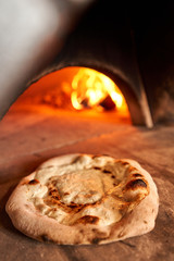 Blank for Fruit pizza. Pizza with raspberries, mascarpone and mint leaves. Traditional wood oven in restaurant, Italy. Original neapolitan pizza. Red hot coal.