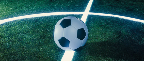 Soccer ball on glowing lines on a field at night