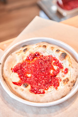 Fruit pizza. Pizza with raspberries, mascarpone and mint leaves. Traditional wood oven in restaurant, Italy. Original neapolitan pizza. Red hot coal.