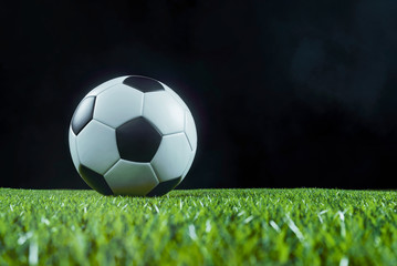 Traditional football on an illuminated sports field at night