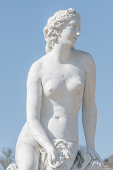 Fototapeta na wymiar Old statue of a sensual naked Renaissance Era woman in the park of Potsdam, Germany, details, closeup