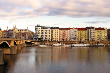 Naklejka premium Vltava river in Prague with dancing house and ancient buildings. World water day.