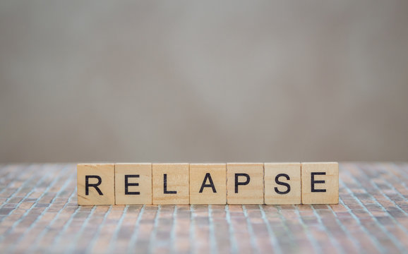 the word relapse, made of wooden cubes
