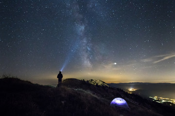 silhouette of man on top of mountain with milky way