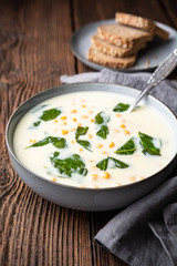 Creamy chickpea and garlic soup with spinach and mashed potatoes, served with whole grain bread