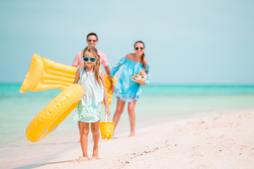 Happy beautiful family on white beach having fun together