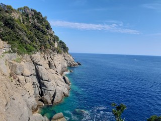 Close-up of big waves breaking on the coast in Liguria, Italy, Europe. White waves of the sea break on the cliff.