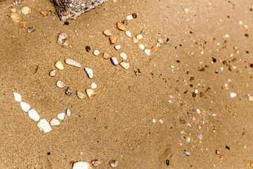 Fototapeta na wymiar inscription stones in the sand the word love