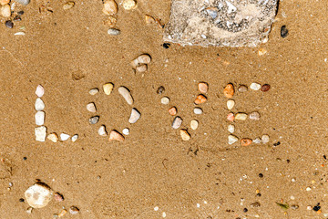 inscription stones in the sand the word love