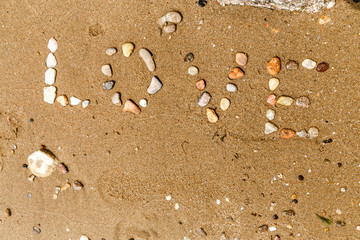 inscription stones in the sand the word love