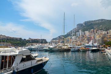 Fototapeta na wymiar Monte-Carlo and his Monaco Bay marina. You can see some parts of the town and harbor with some of the most beautiful boats in the world