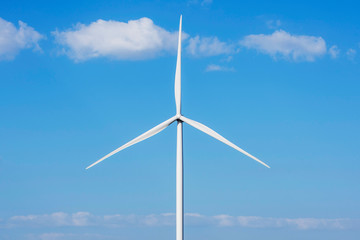 Wind turbine generate electricity on blue sky background. Energy conservation concept. Producing alternative energy