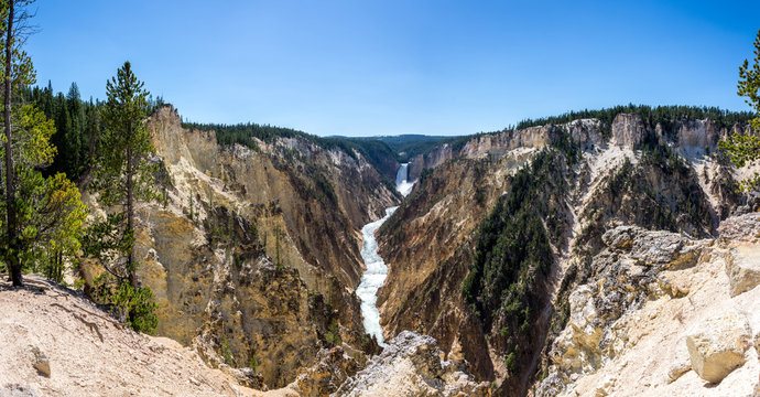 panoramic picture of the lower falls waterfall on a sunny day in the yellowstone national park, wyoming, united states of america
