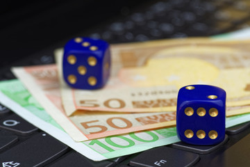 Two dices and euro banknotes on keypad