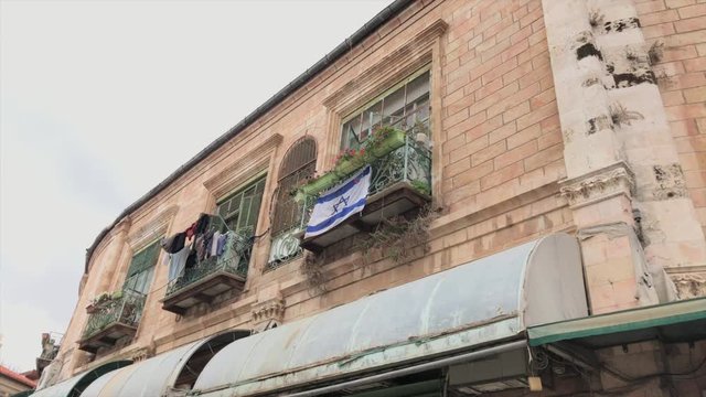 Israeli flagg blowing in the wind on a balcony, Jerusalem, Israel