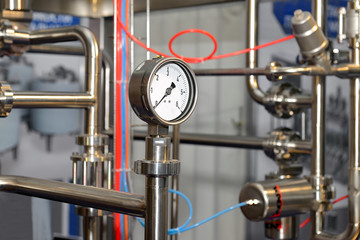 Pressure gauge on milk pipeline in production of dairy products