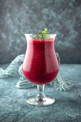 Berry smoothie. On a turquoise background. Cocktail menu. Sea mood concept.