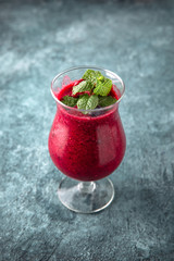 Berry smoothie. On a turquoise background. Cocktail menu. Sea mood concept.
