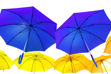 Fototapeta na wymiar Blue and yellow umbrellas on a white isolated background