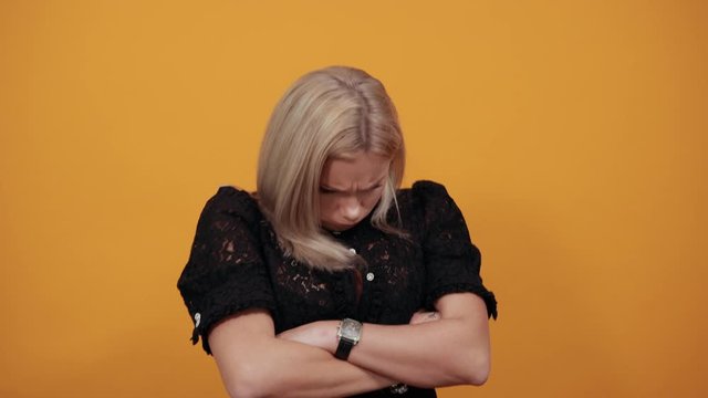 Young offended angry woman folded her arms, being angry on her boyfriend. Negative facial human emotion.