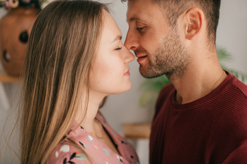 Portrait of a couple in love hugs together at home and smiles