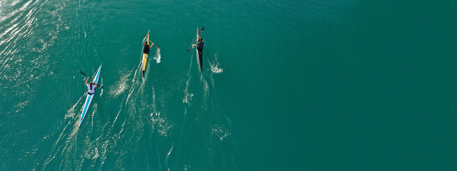 Aerial drone ultra wide photo of women athletes competing in sport canoe in tropical exotic lake