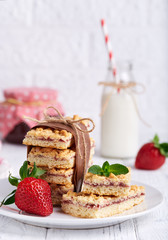 Pie bars with strawberry jam . Delicious homemade sweet dessert from shortcrust pastry. 