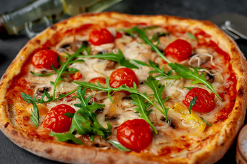tasty italian pizza with mozzarella cheese, mushrooms, tomato, bell pepper, onion on a stone background