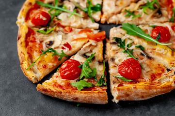 tasty italian pizza with mozzarella cheese, mushrooms, tomato, bell pepper, onion on a stone background