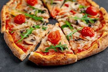 tasty italian pizza with mozzarella cheese, mushrooms, tomato, bell pepper, onion on a stone background