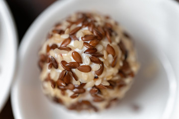 Cream cheese balls coated with white and brown sesame seeds. Tasty treat-2.