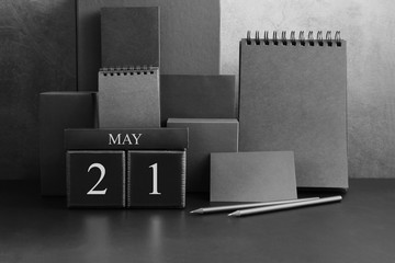 May 21th. Day 21 of month. Wood cube calendar with date month and day. Trendy classic black color. Lot of empty pages template for daily notes.