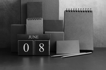 June 8th. Day 8 of month. Wood cube calendar with date month and day. Trendy classic black color. Lot of empty pages template for daily notes.