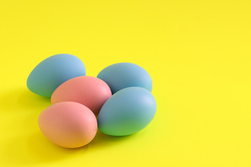Easter eggs on the yellow background. Holiday and spring background.