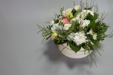 Bright floral arrangement in pastel colors in a hat box, greeting concept