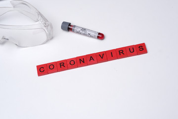 Obraz premium Coronavirus all over the world. The picture with blood sample and coronavirus written by scrabble.