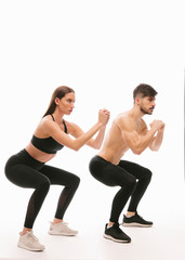 Obraz na płótnie Canvas Couple doing squats 