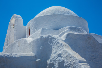 Old mediterranean architecture white Greek church under the sun in Mykonos, Cyclades, Greece 