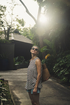 Woman in a tropical garden, Nai Thon Beach, Phuket, Thailand