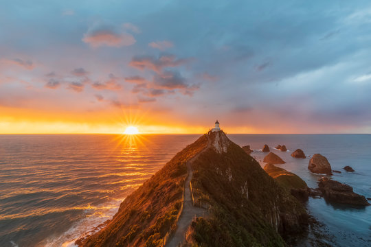 New Zealand, Oceania, South Island, Southland, Otago, Southern Scenic Road, Cape Nugget Point, Nugget Point Lighthouse at sunrise