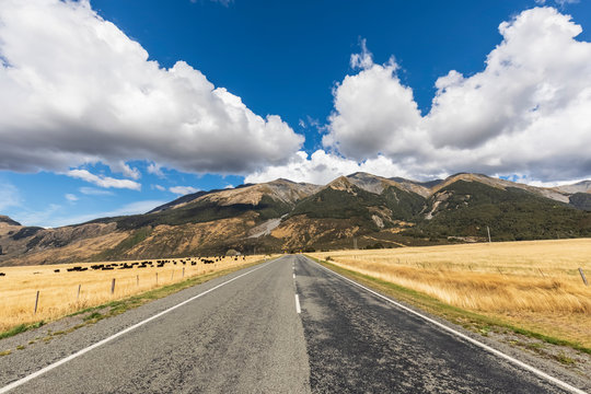 New Zealand, Grey District, Inchbonnie, Clouds over empty State Highway 73 with mountains in background