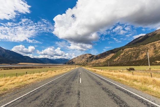 New Zealand, Grey District, Inchbonnie, Clouds over empty State Highway 73 with mountains in background
