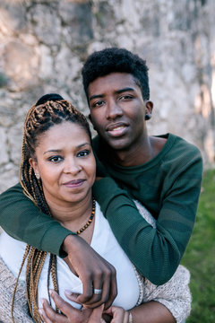 Portrait of smiling mother with teenage son outdoors