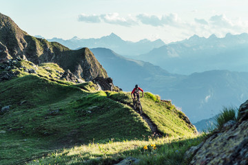 Mountain biker on a way on a ridge, Grisons, Switzerland