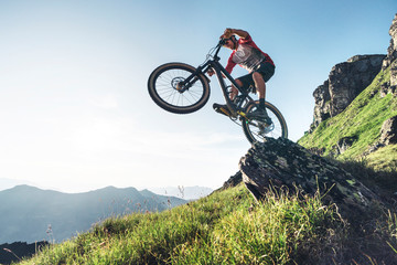 Mountainbiker mountain biking against the sun in Grisons, Switzerland