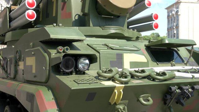 Close up of a military tank with a heavy armour and wheels. New modern military vehicle. Military technology development.