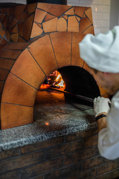 Original neapolitan pizza margherita in a traditional wood oven in restaurant